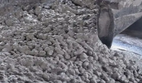 High-quality wet concrete mix A picture showing a thick, wet concrete mix containing cement, sand, gravel, and water, used in construction and building works, from ICHEM Company