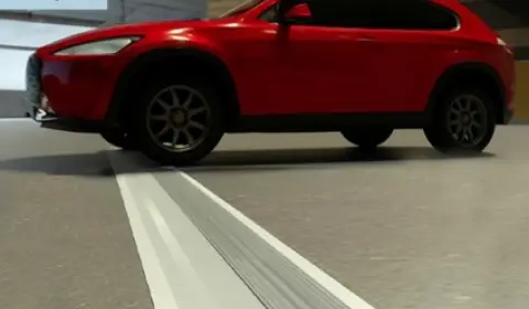 ichem: Durable Solutions for Floor Expansion Joint Covers A red car parked over an ichem floor expansion joint cover, demonstrating its durability in parking garages