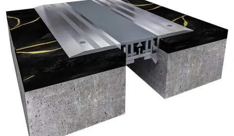 ichem: Durable Solutions for Floor Expansion Joint Covers A red car parked over an ichem floor expansion joint cover, demonstrating its durability in parking garages